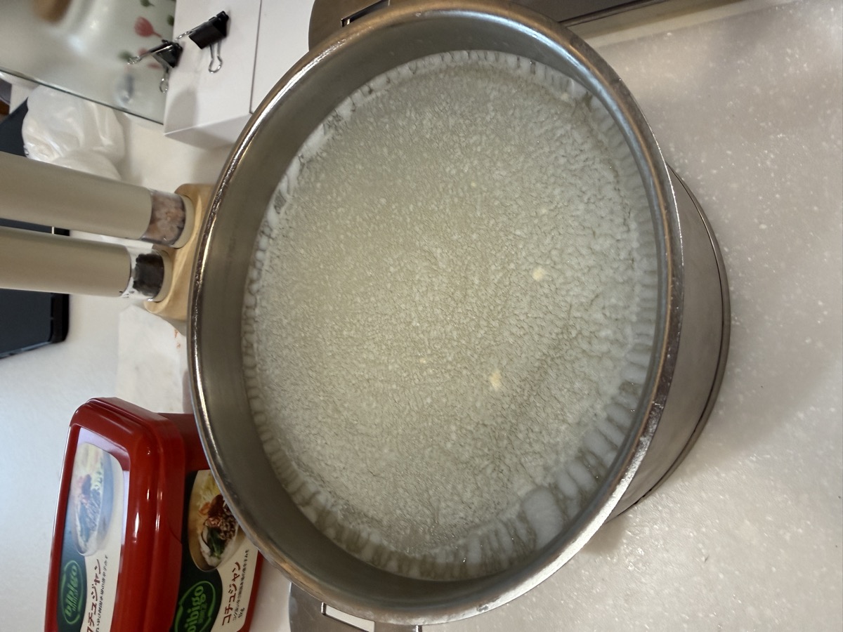 Removing the solidified white fat crust after overnight chilling in the refrigerator