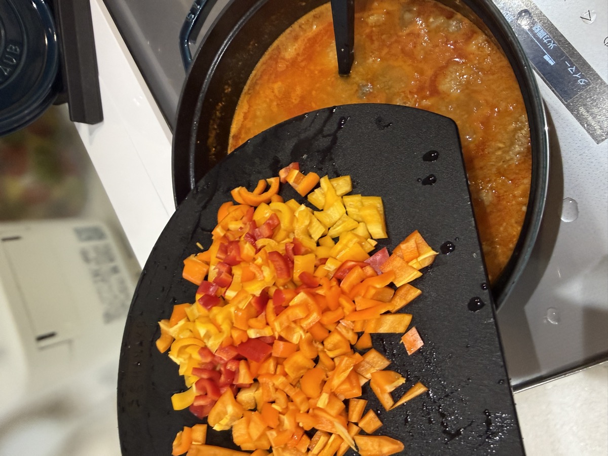 Adding vibrant diced red and yellow sweet mini paprika for vitamins and visual appeal